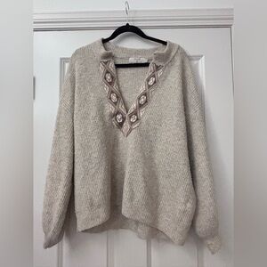 Chic Beige V-Neck Sweater with Intricate Pattern